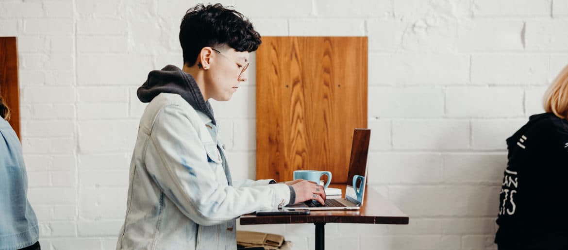 a person using a laptop on a table.