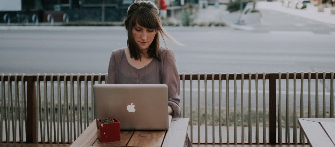 A woman working remotely from a table with potential pitfalls.