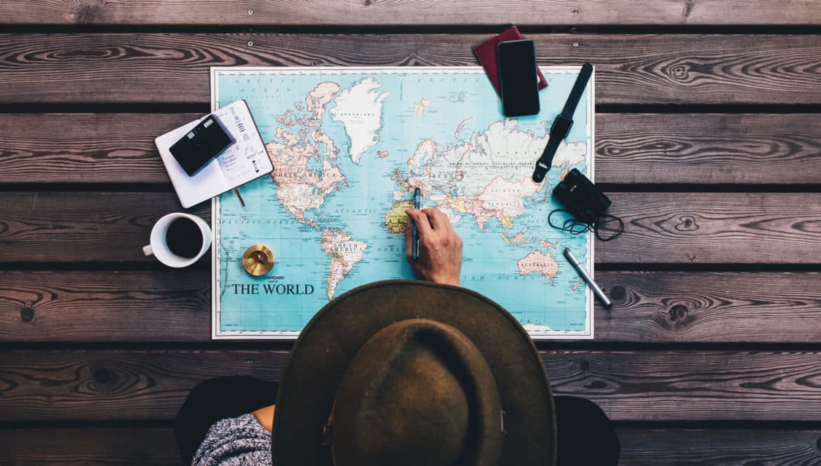 a person sitting at a table looking at a map.