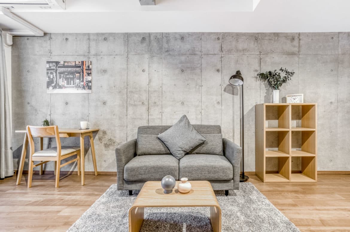 A Hmlet living room with furniture and a wooden table.