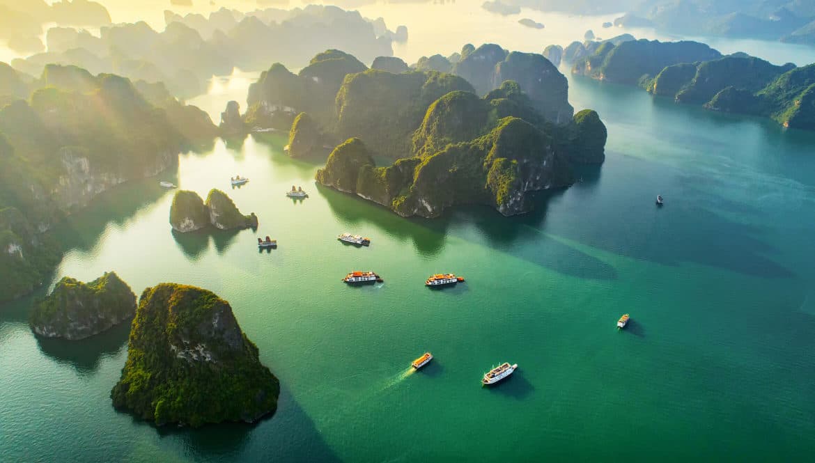 a group of boats floating on top of a body of water.