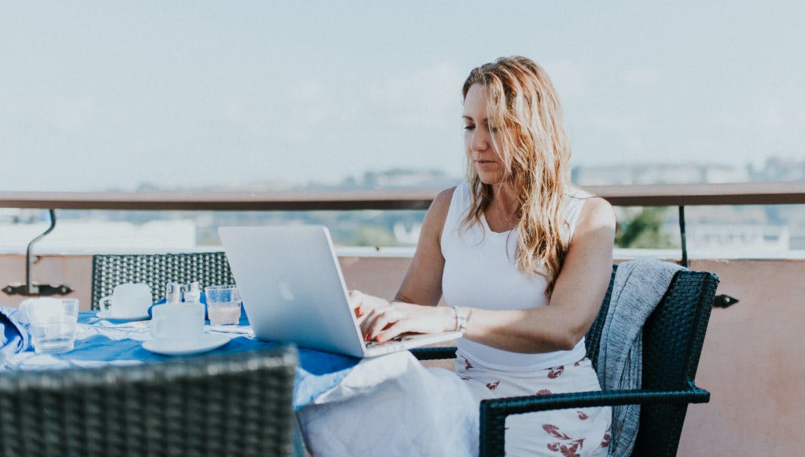 digital nomad getting work done on rooftop