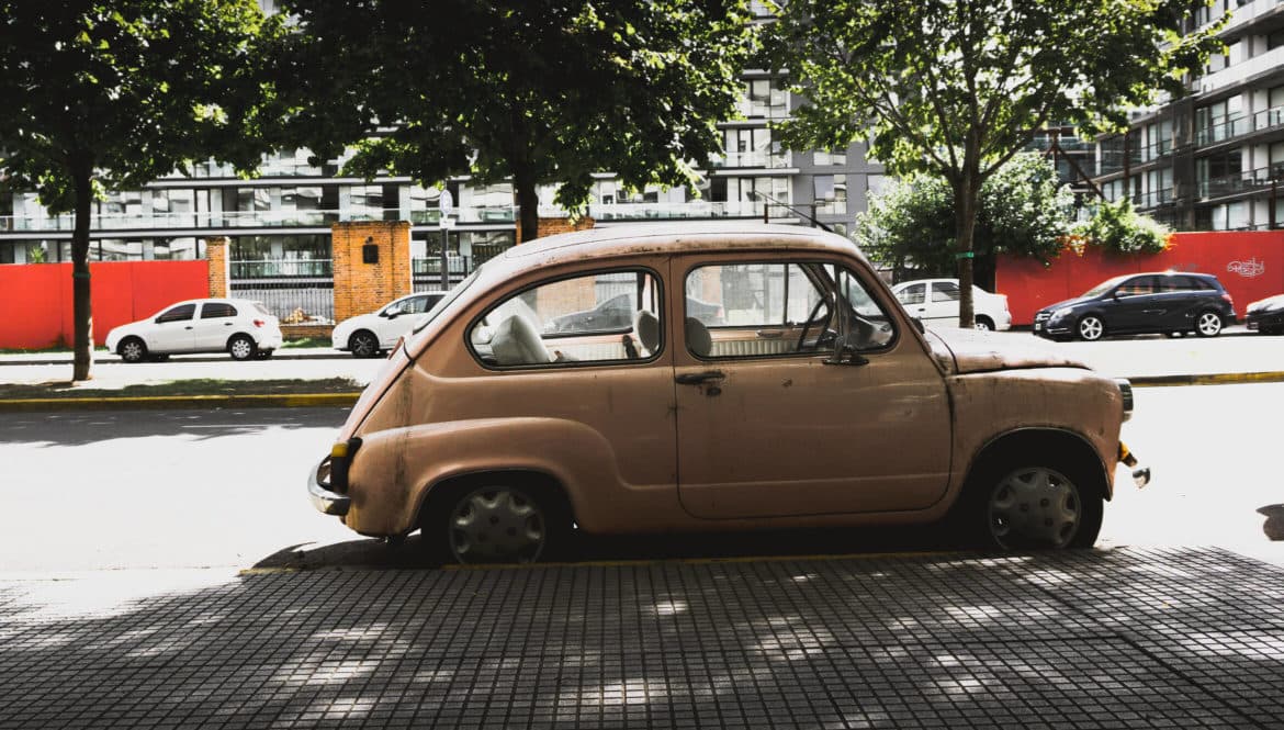 A small car parked on the side of the road in Argentina.