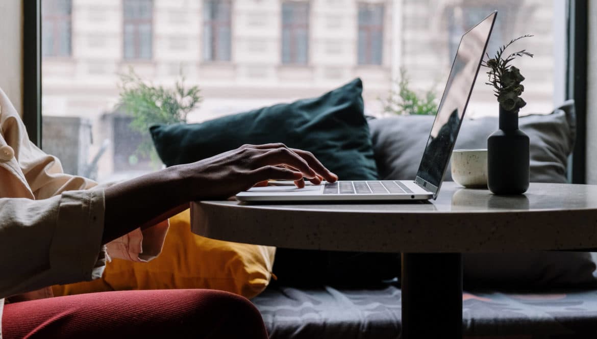 woman working on laptop in cafe