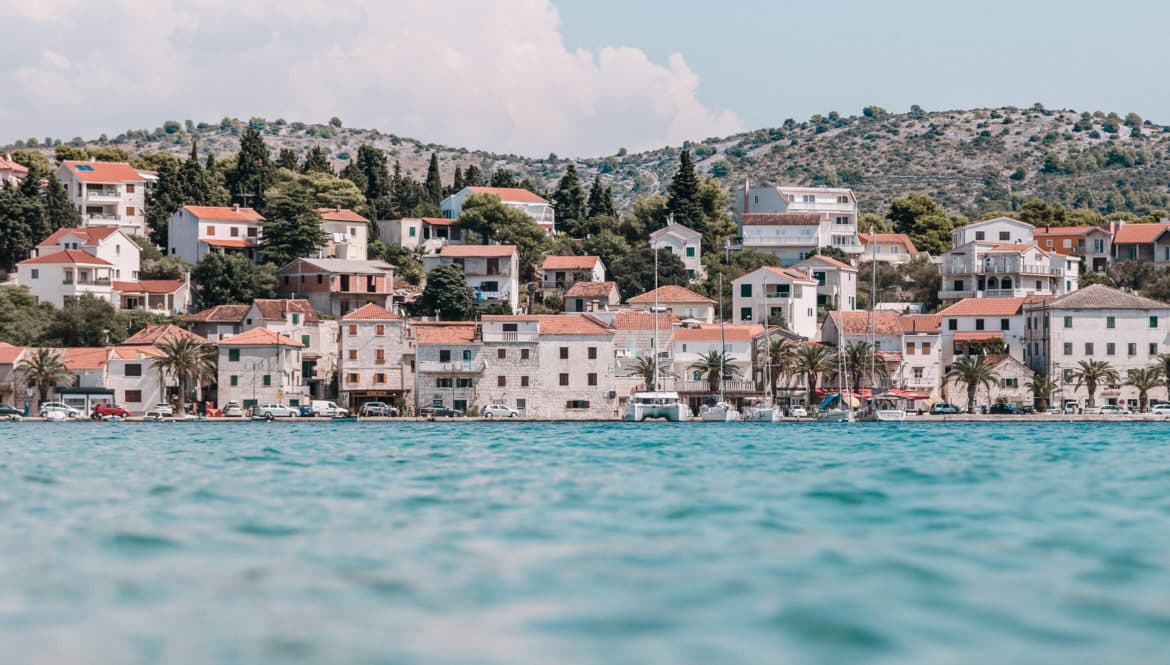 a large body of water with a bunch of houses in the background.