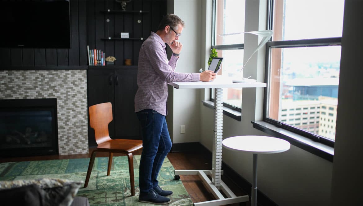 man working from a standing desk