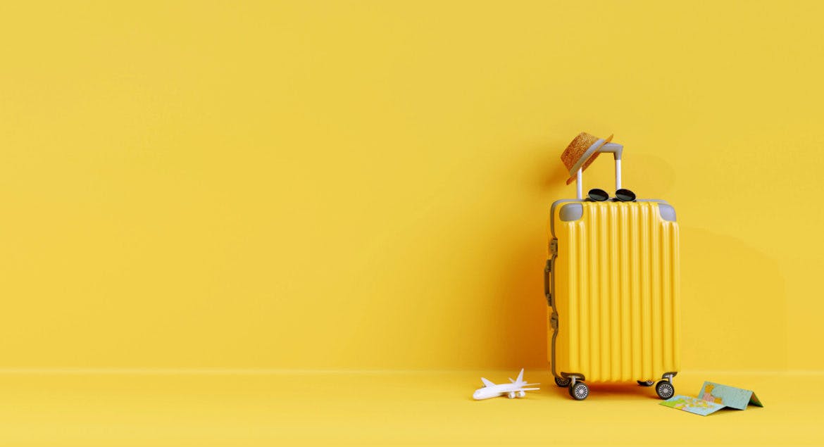 A minimalist yellow suitcase on a yellow floor.