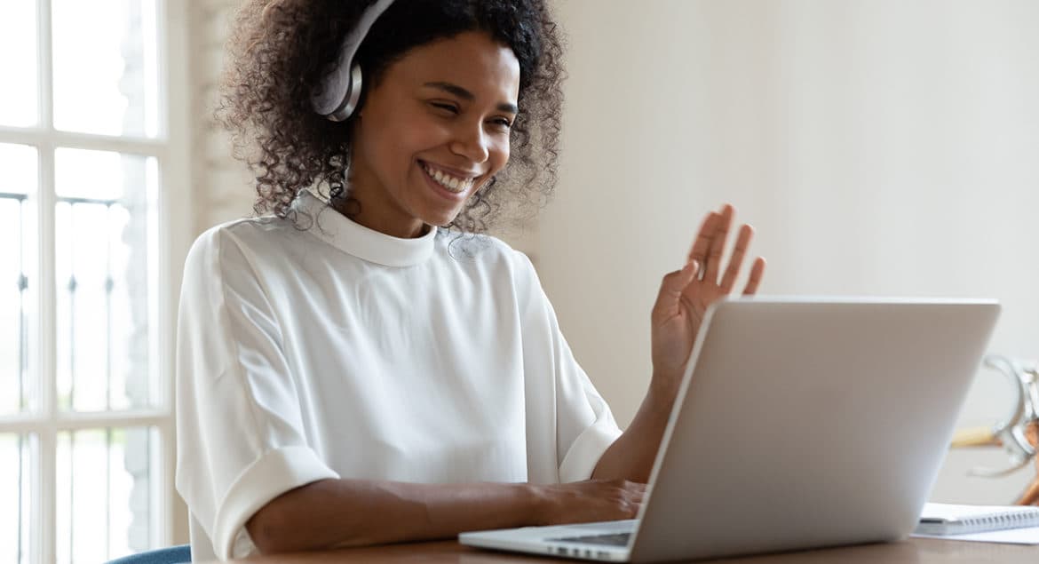 A woman preparing for a virtual interview on her laptop.