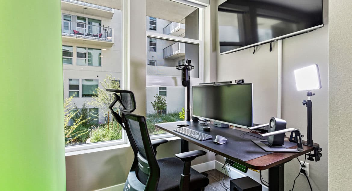 An office computer desk with a monitor and keyboard.