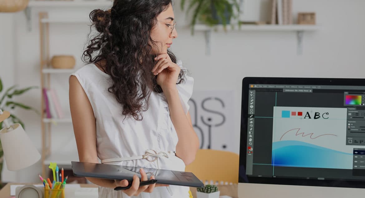 A relocating woman in front of a computer screen.