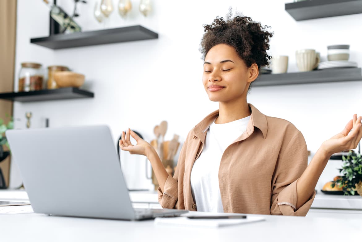 A skilled woman sitting in front of a laptop computer.