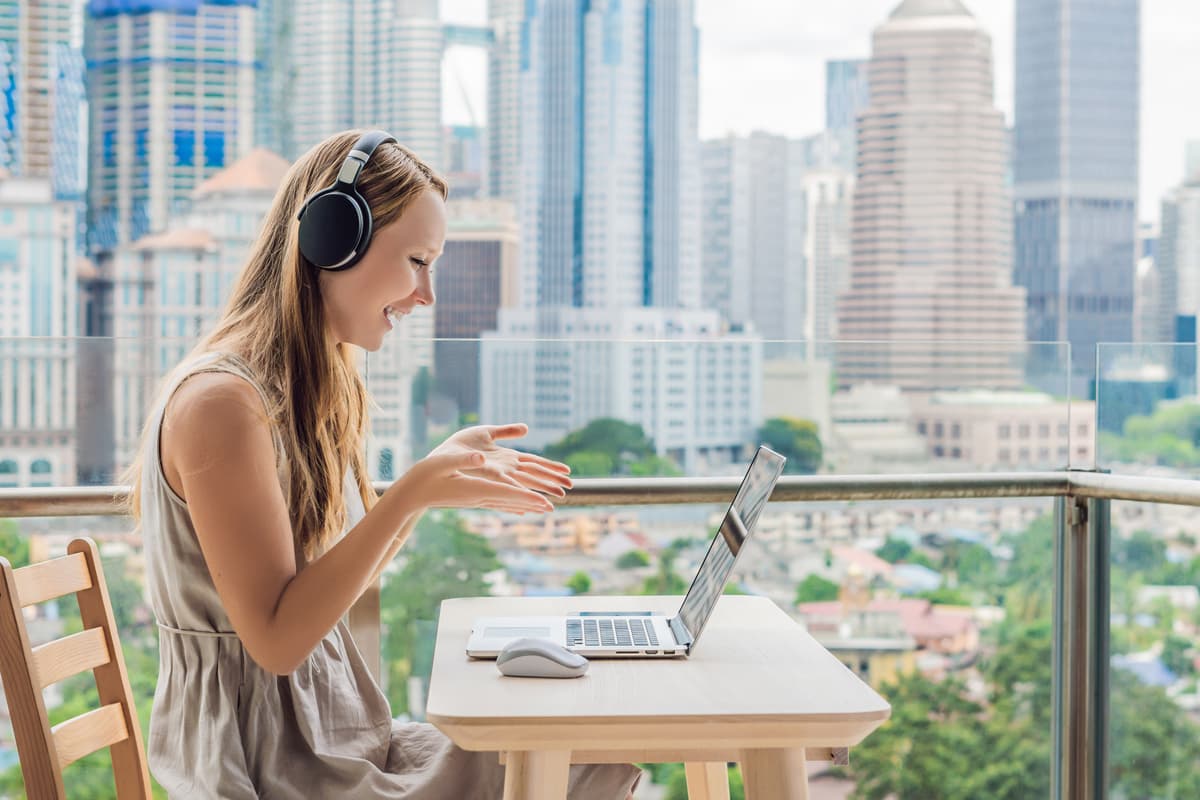 a woman working remotely on her laptop at a table.