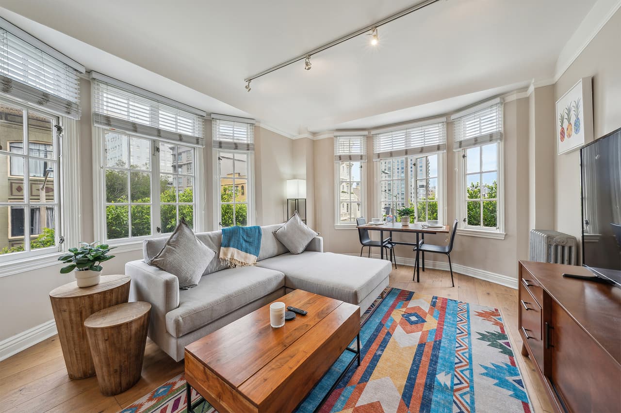 Bright and airy living room with modern furnishings and large windows.